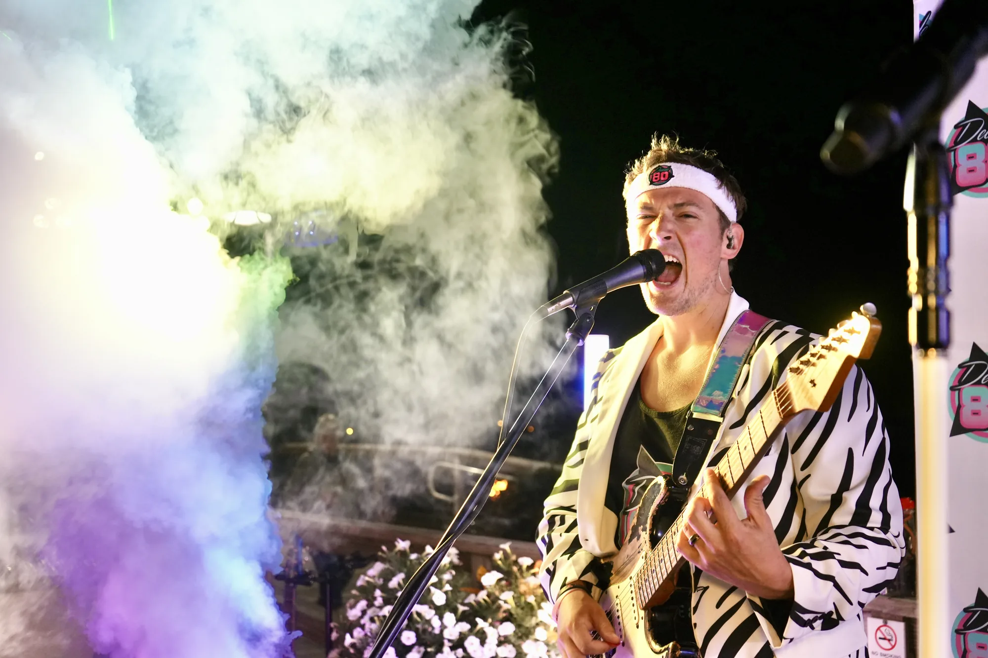 Decade80 guitarist singing through stage smoke