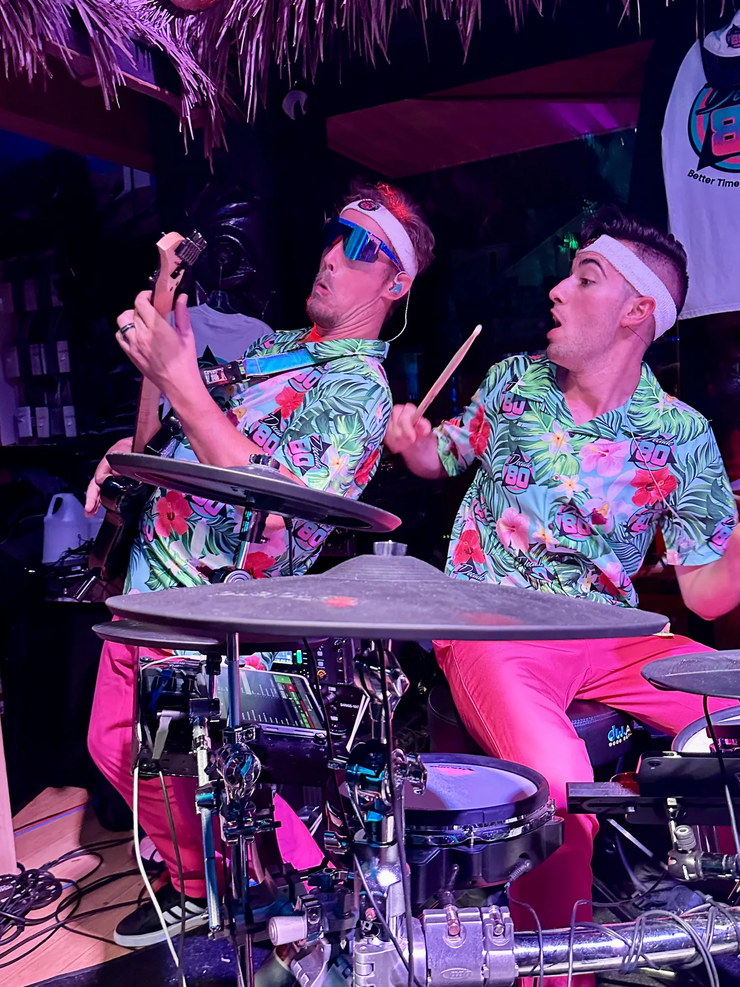 Two Decade80 bandmates performing in matching Hawaiian shirts