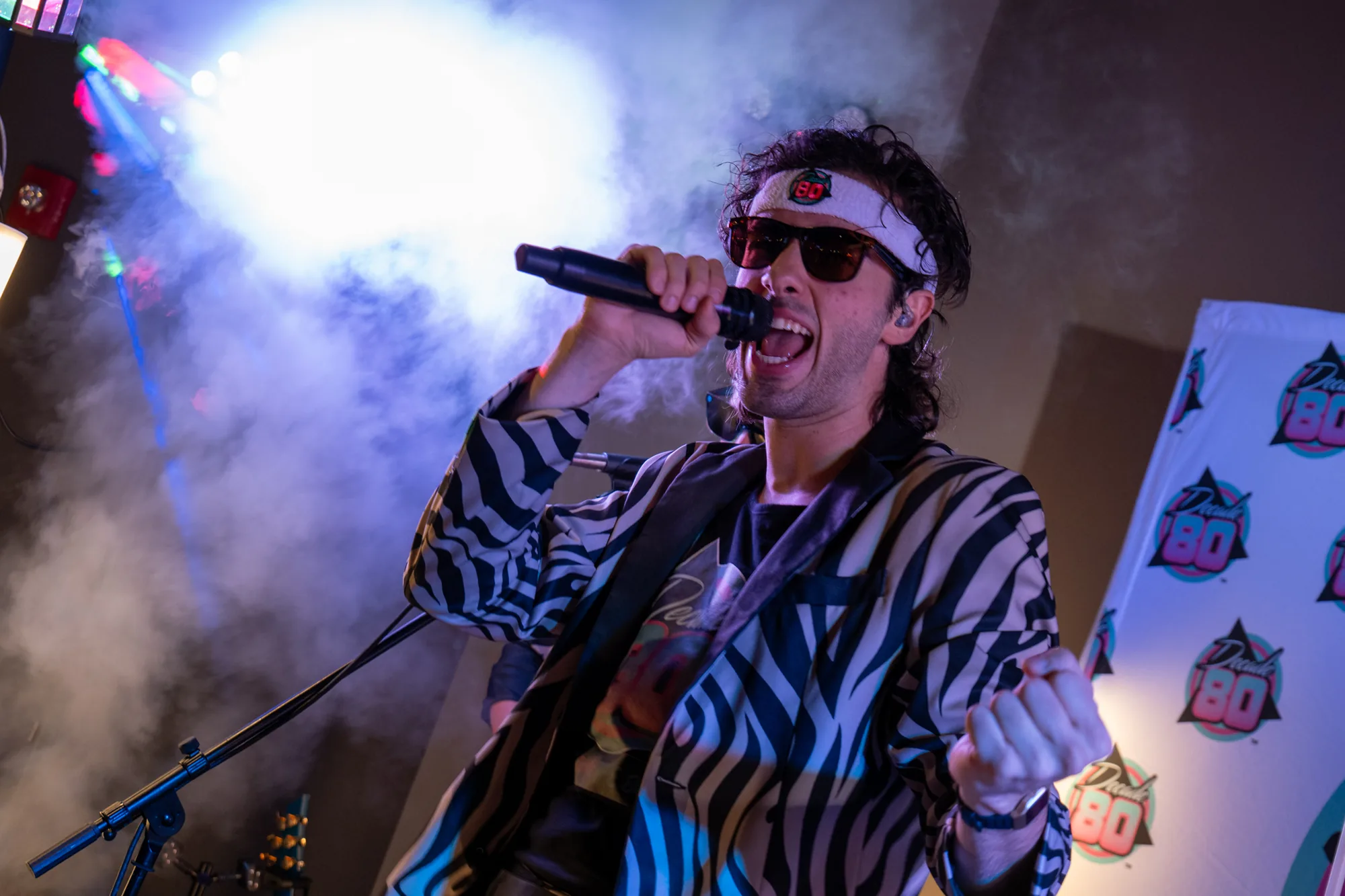 Decade80 singer performing in sunglasses and a zebra jacket