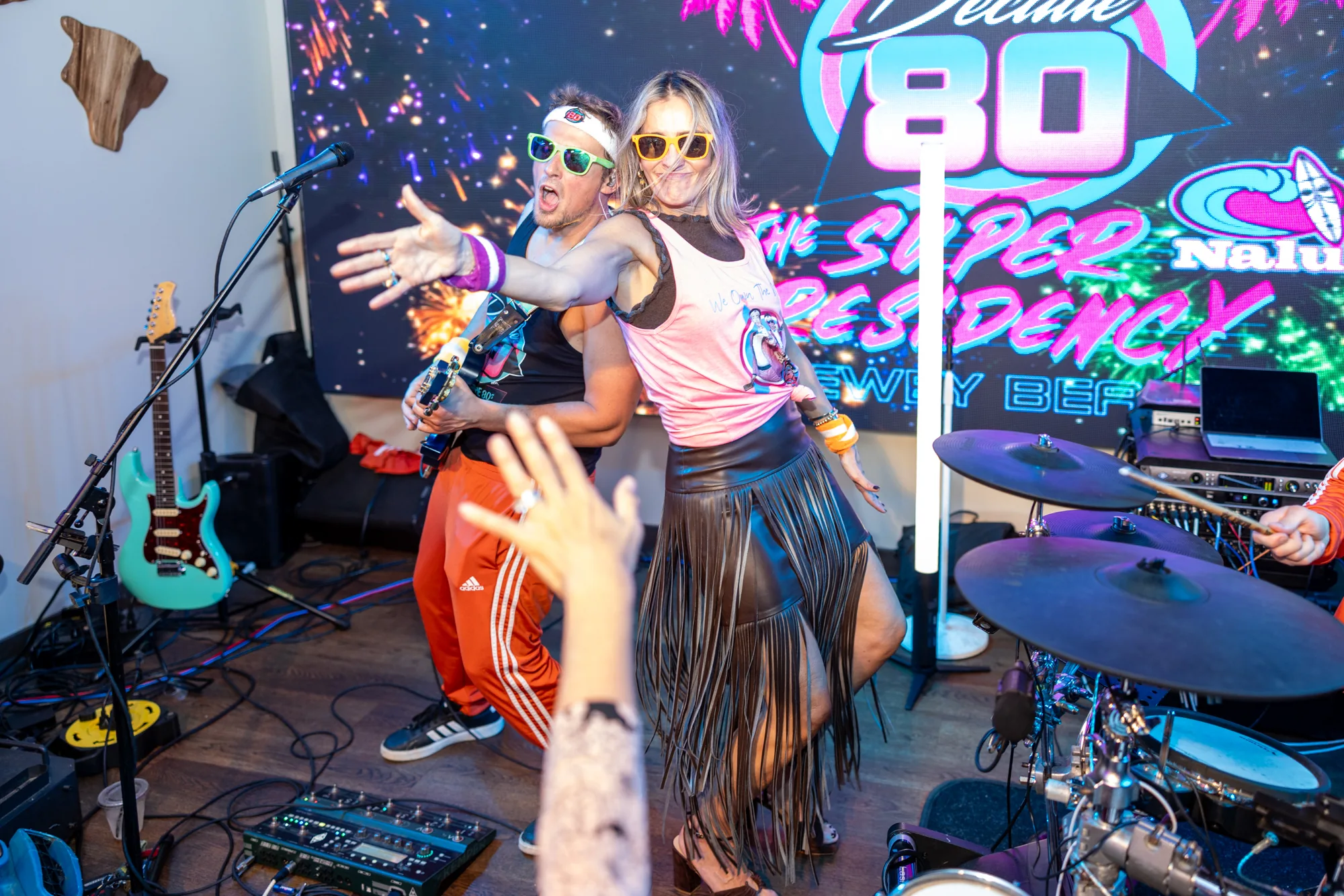 A fan posing with the guitarist at a Decade80 show